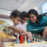 Teacher guiding a child with colourful learning materials