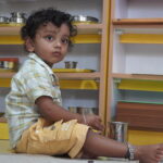 Boy working carefully with small learning materials