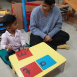 Children sorting small coloured beads