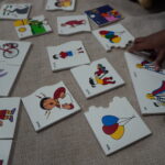 Colourful shape and picture cards laid out on a mat