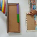 Wooden tray holding colourful learning rods