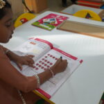 Close-up of a child's hands working with small learning pieces