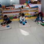 Children working on separate activities on the classroom floor